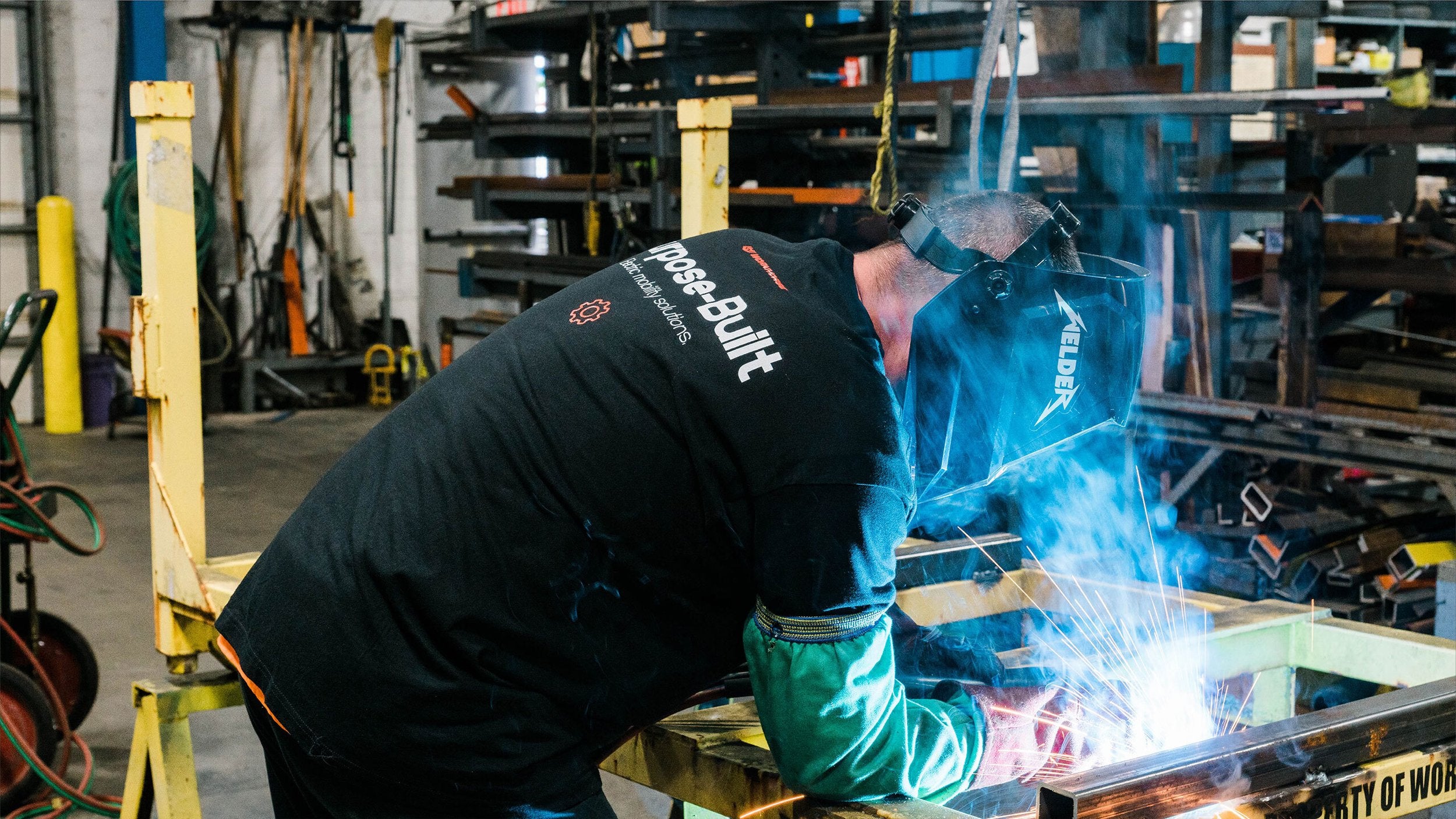 workhorse ev worker welding a chassis